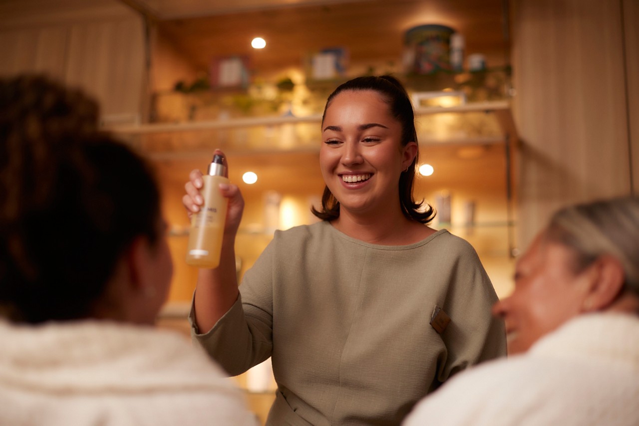 Spa therapist demonstrating product use