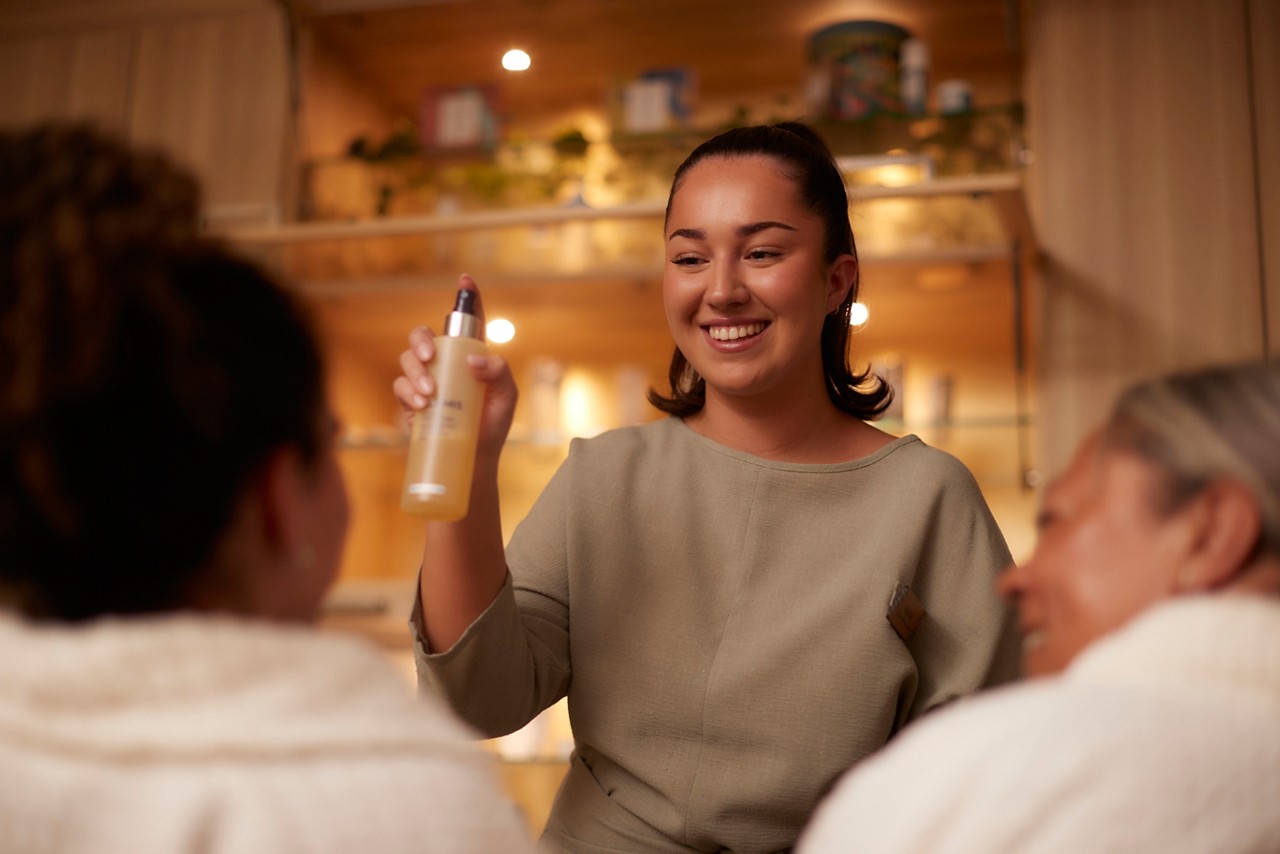 Spa therapist demonstrating product use