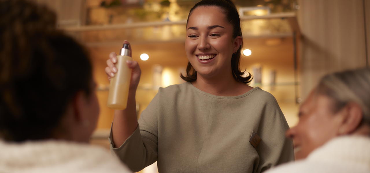 Spa therapist showing off products inside the discovery area.