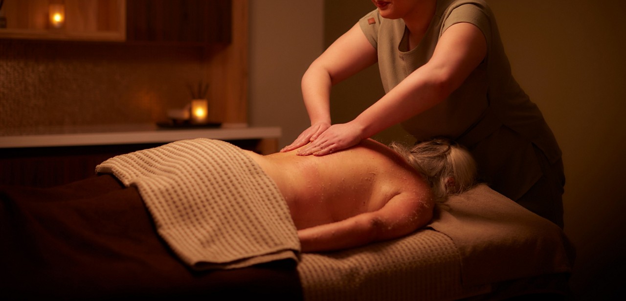 Woman having VOYA products applied to her back.
